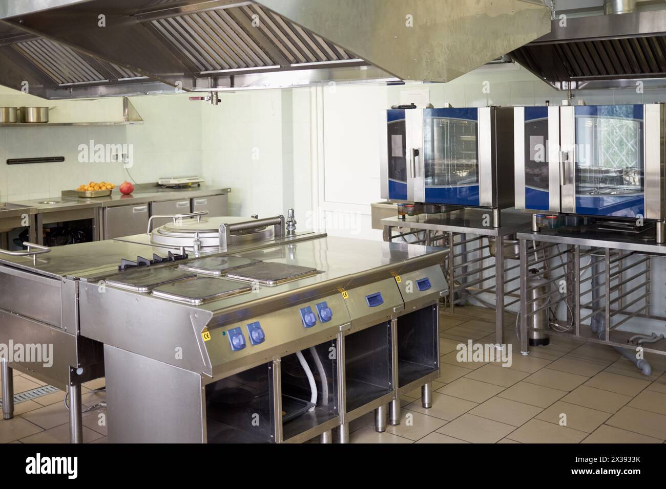 Kitchen room with stoves, sinks and refrigerators in restaurant. Stock Photo