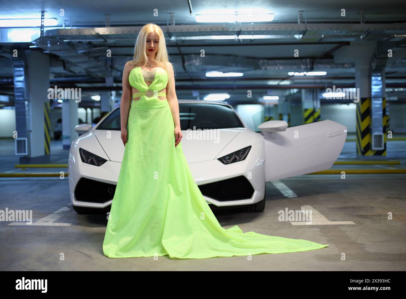 MOSCOW - MAY 20, 2016: Beautiful woman (with MR) in long dress near Lamborghini Huracan LP 610-4. Lamborghini Huracan is world first production car, u Stock Photo