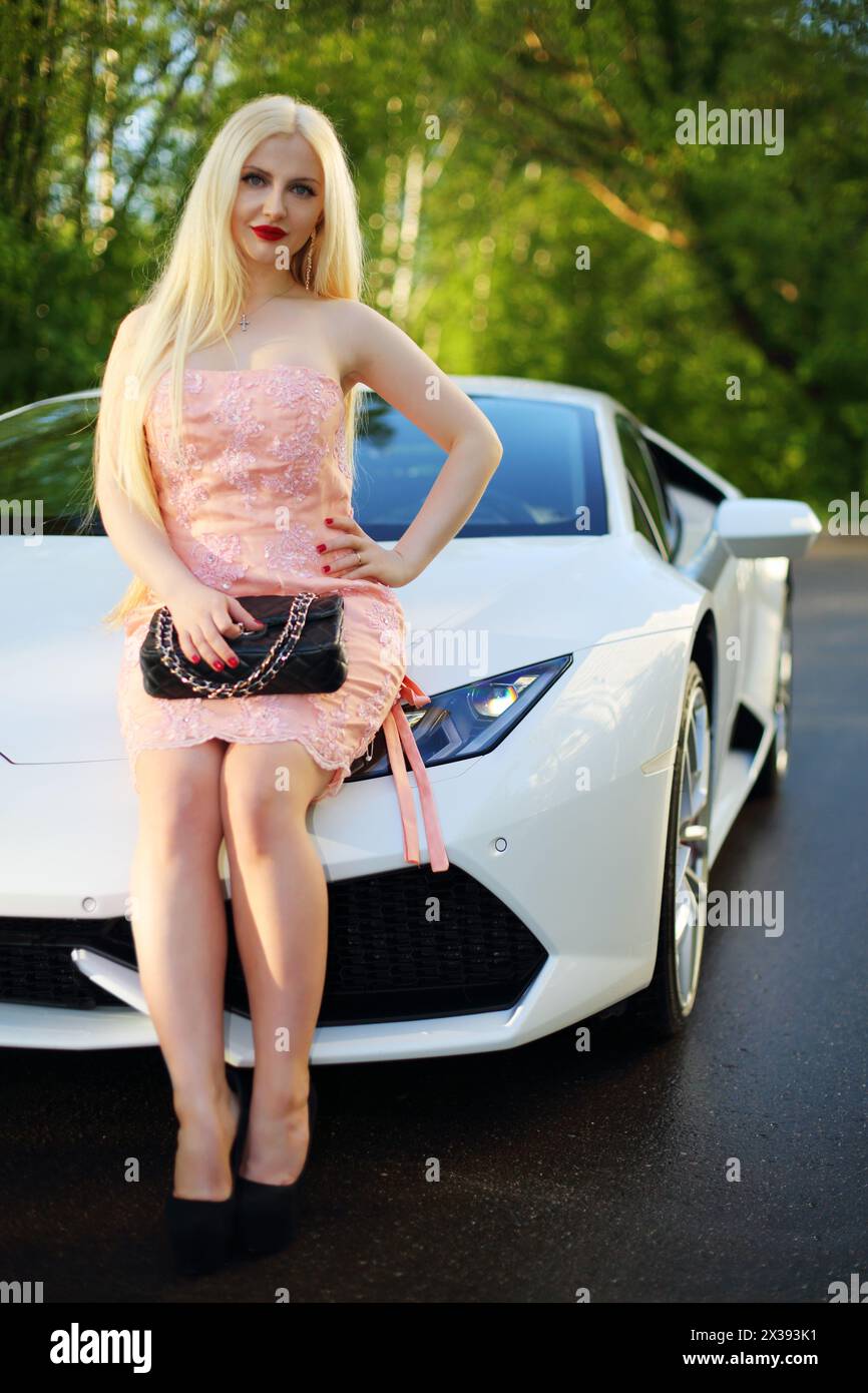 MOSCOW - MAY 20, 2016: Young woman (with MR) pose near at Lamborghini Huracan LP 610-4. Lamborghini Huracan is world first production car, using inert Stock Photo