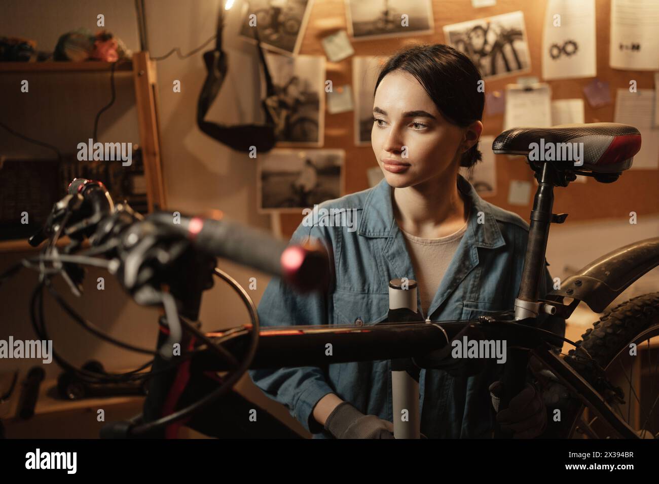 Portrait repair woman in bicycle workshop. Cycling garage and startup. Confident bike female mechanic Stock Photo