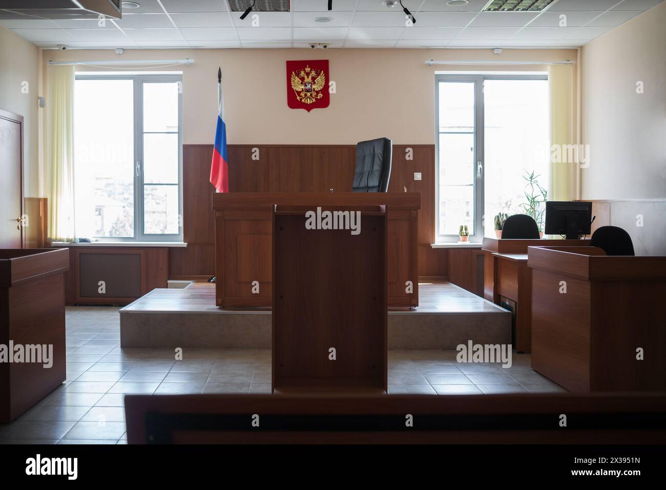MOSCOW, RUSSIA - JUL 1, 2015: Wooden furniture in court of law with Russian coat of arms Stock Photo