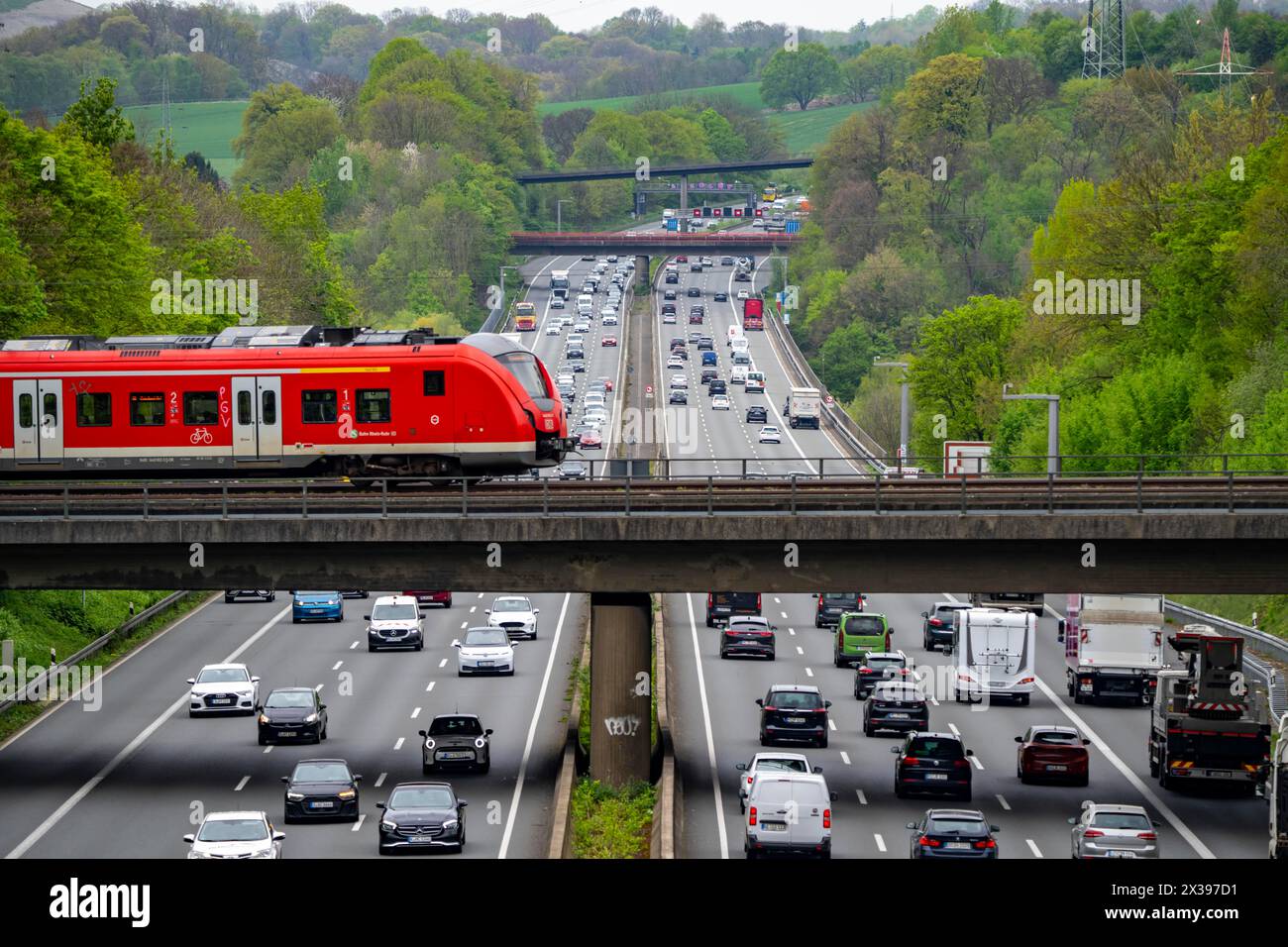 S-Bahn train crossing the highway A3, traffic on 8 lanes, incl. the ...