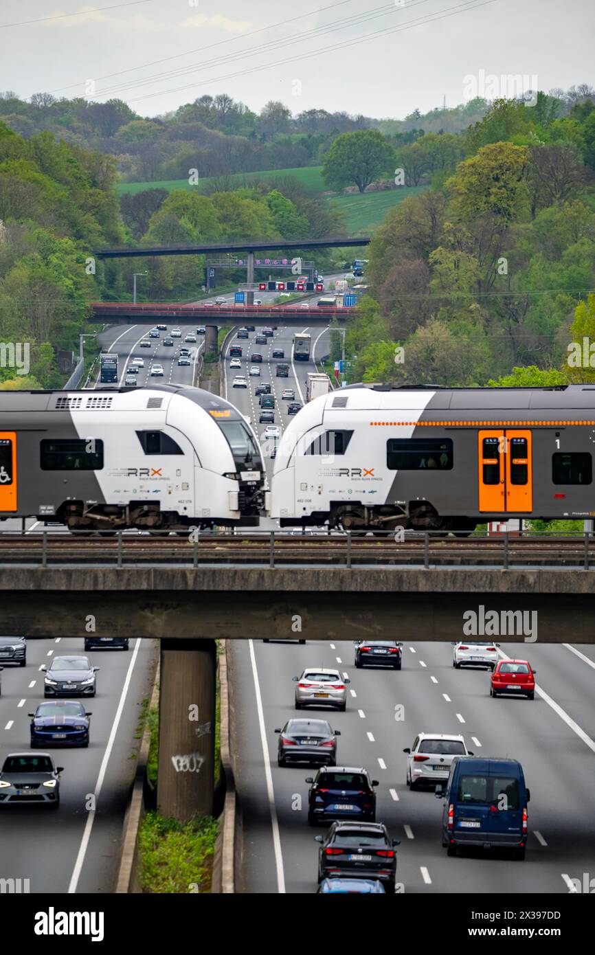 Rhein-Ruhr-Express, RRX train crosses the highway A3, traffic on 8 lanes, incl. the temporarily released hard shoulder, behind the highway junction Hi Stock Photo