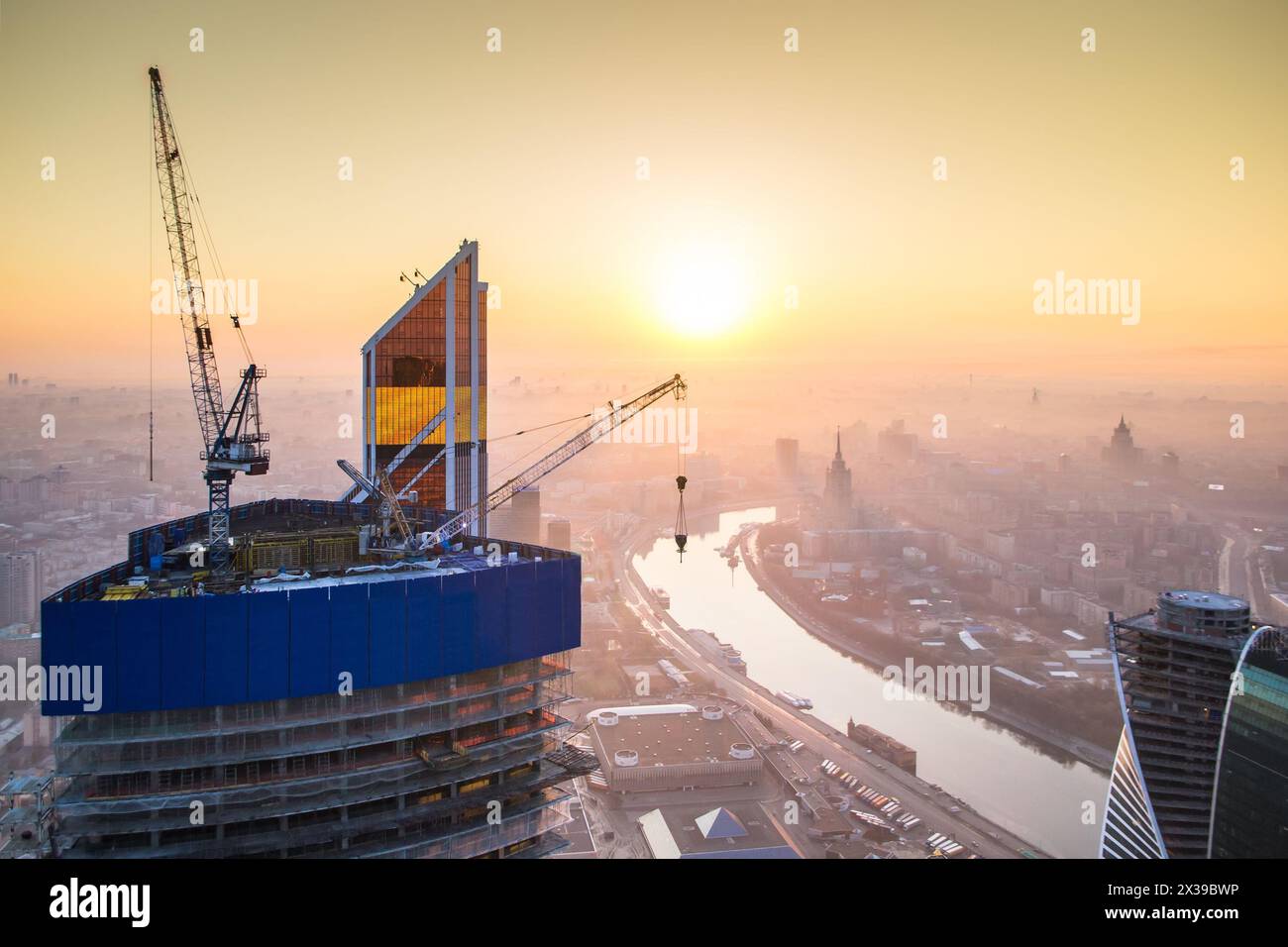 Sunrise in the foggy day over Moscow. Top view from building under construction Stock Photo