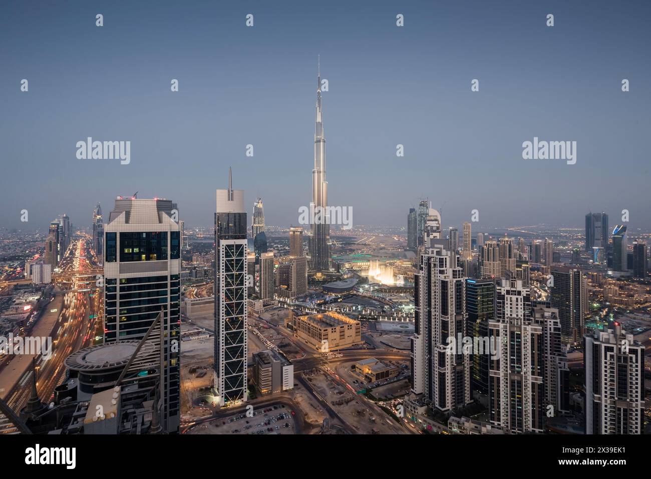 DUBAI, UAE - JAN 9, 2017: Evening Millenium Tower and Burj Khalifa, Executive Towers at night, Burj Khalifa - skyscraper in height of 828 meters in Du Stock Photo
