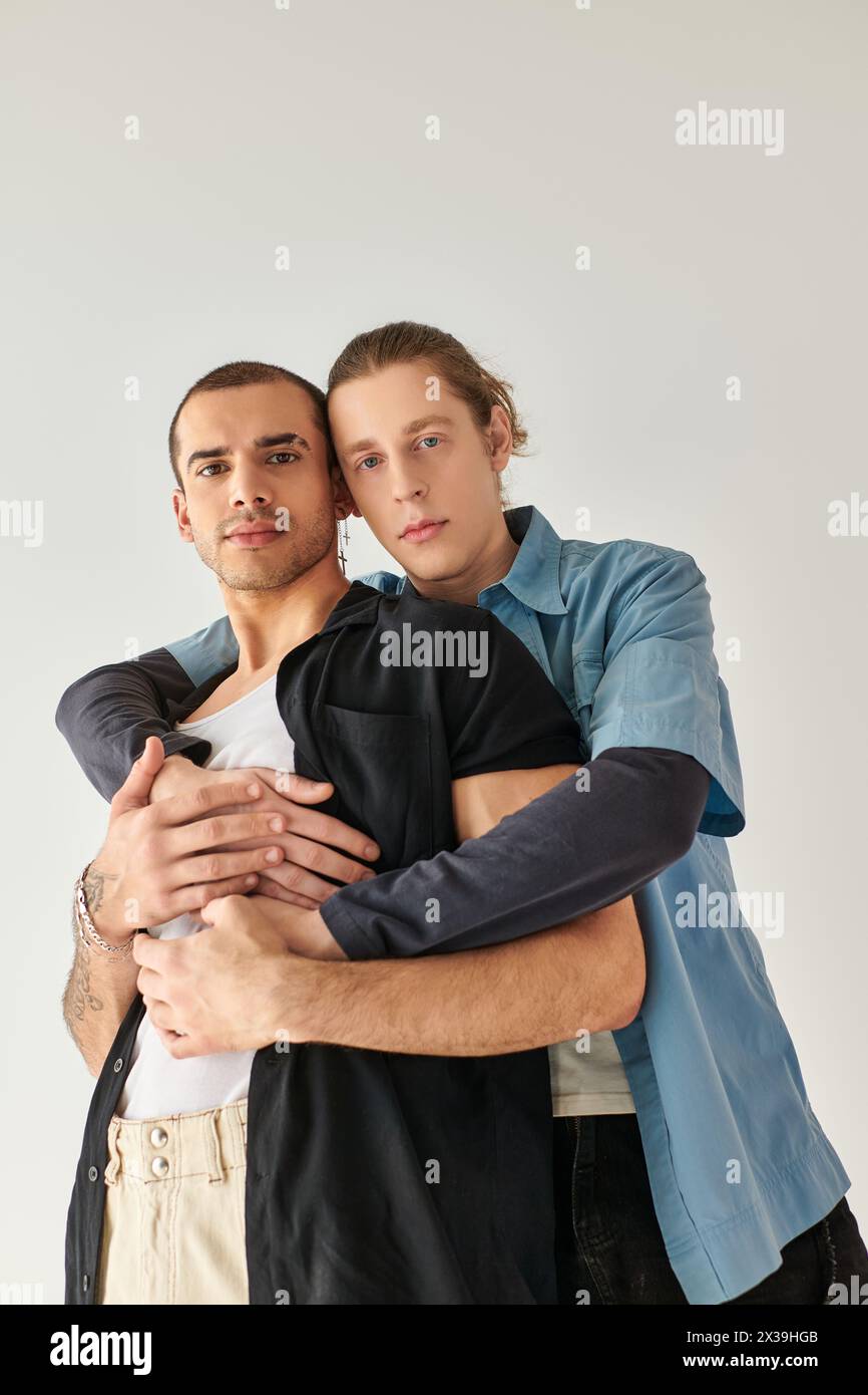Two men hugging each other in a tender embrace. Stock Photo