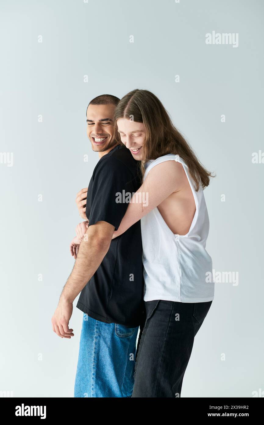 A loving gay couple, two men, embrace each other in a warm, supportive hug. Stock Photo