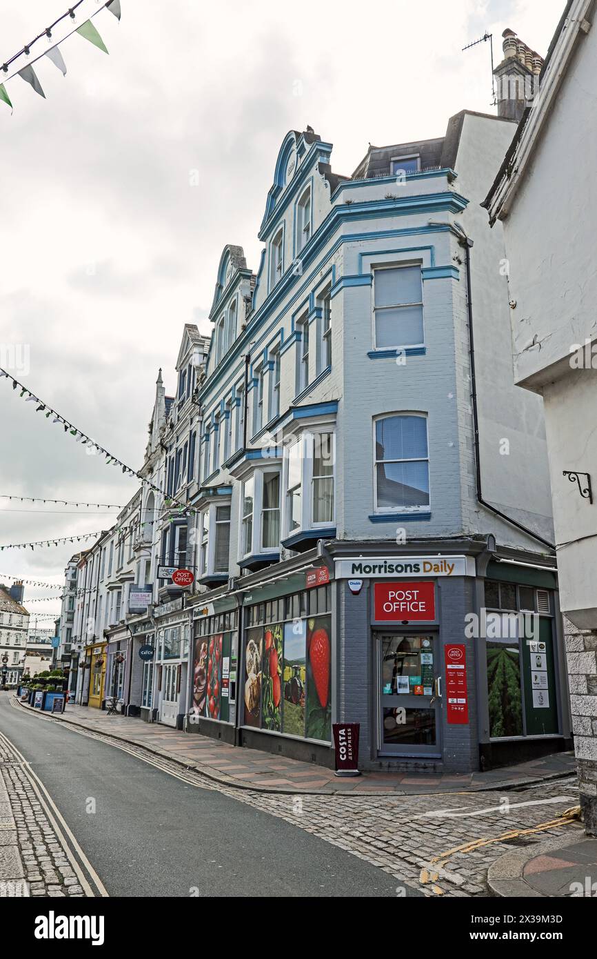 Morrisons Daily convenience store and post office on a corner of a row of shops in Southside Street, Plymouth Stock Photo