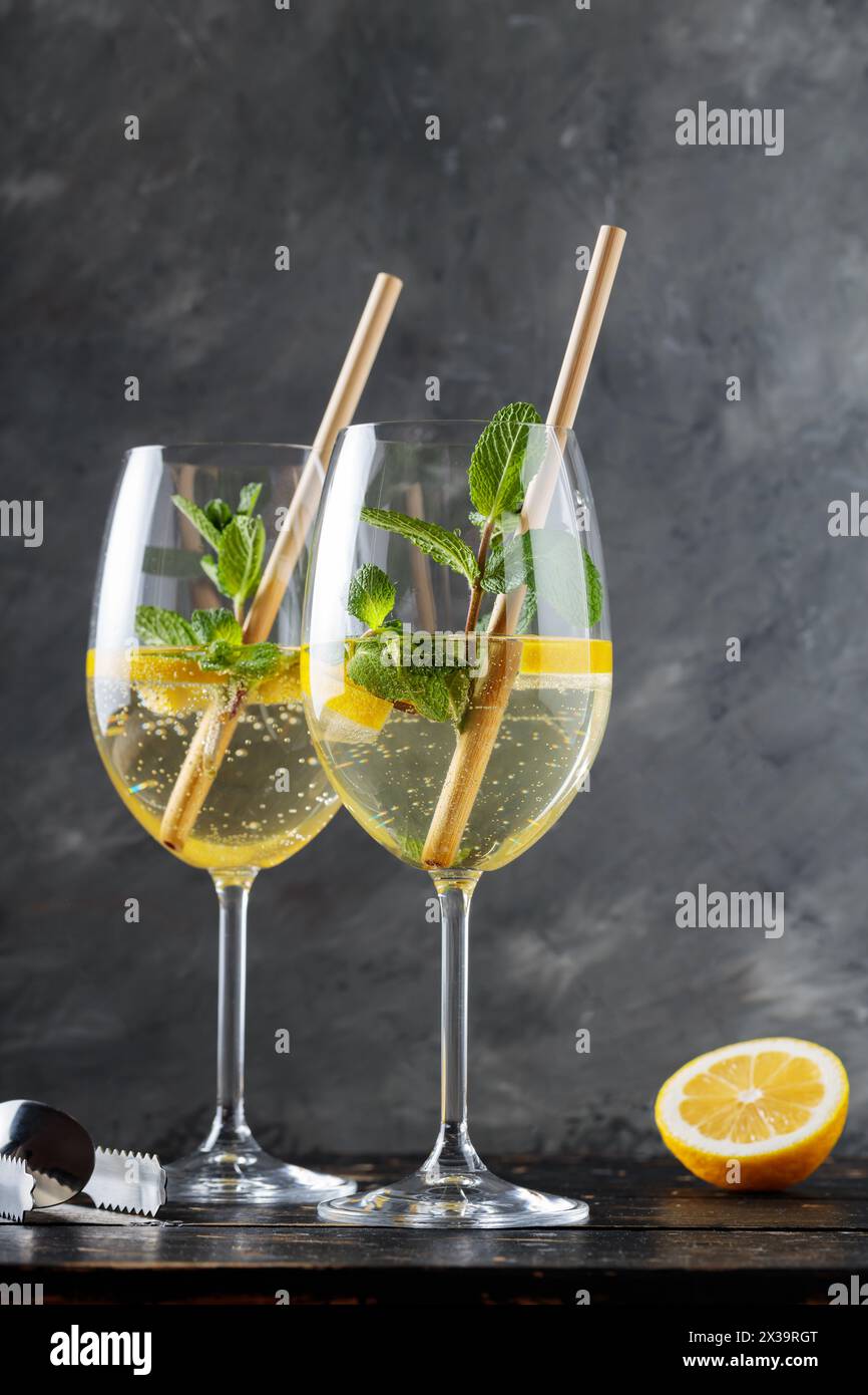 Refreshing Hugo Spritz Cocktail with Elderflower Liqueur, Mint and Lemon on Dark Background Stock Photo