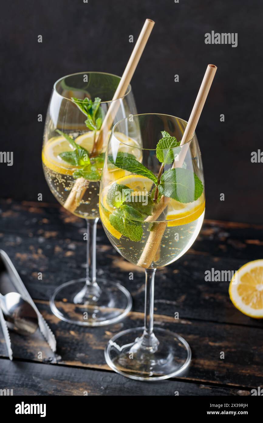 Refreshing Hugo Spritz Cocktail with Elderflower Liqueur, Mint and Lemon on Dark Background Stock Photo