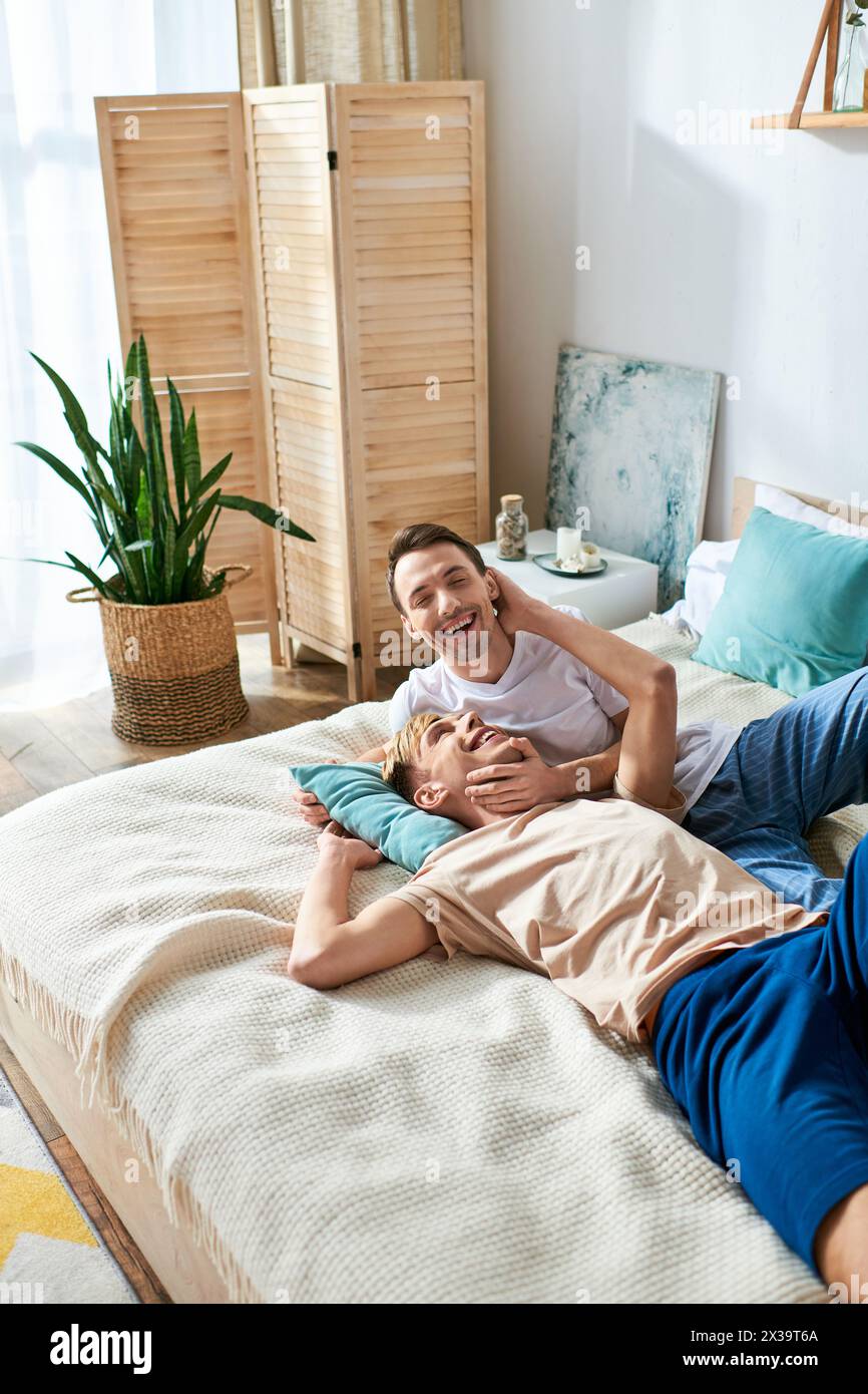 Two men peacefully laying together on a bed Stock Photo - Alamy
