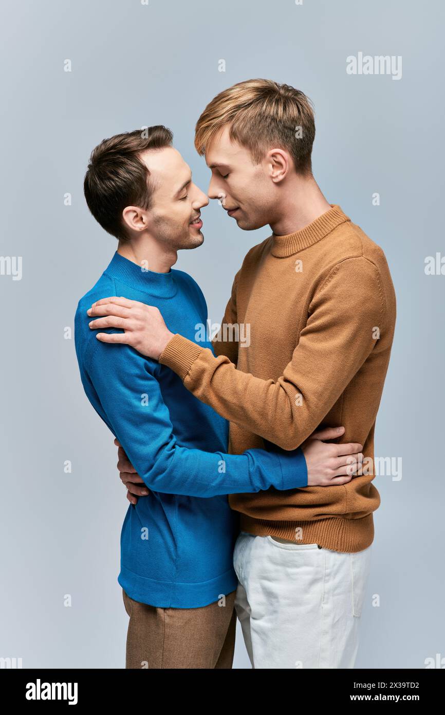 Two men in casual attire embracing in a loving stance Stock Photo - Alamy