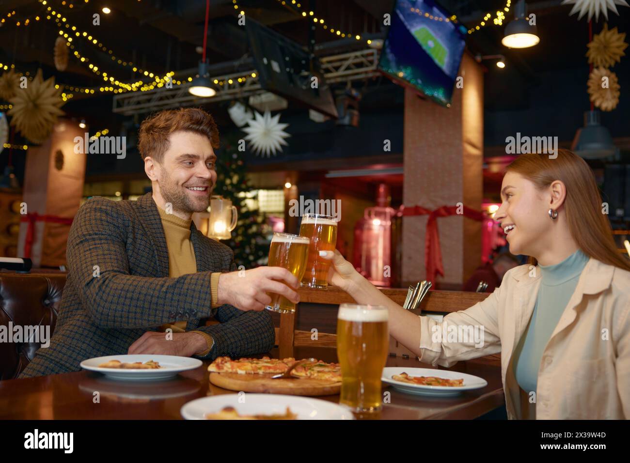 Friends drinking beer while rest in pub Stock Photo