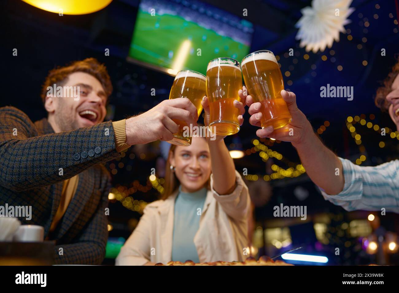 Friends drinking beer while rest in pub Stock Photo