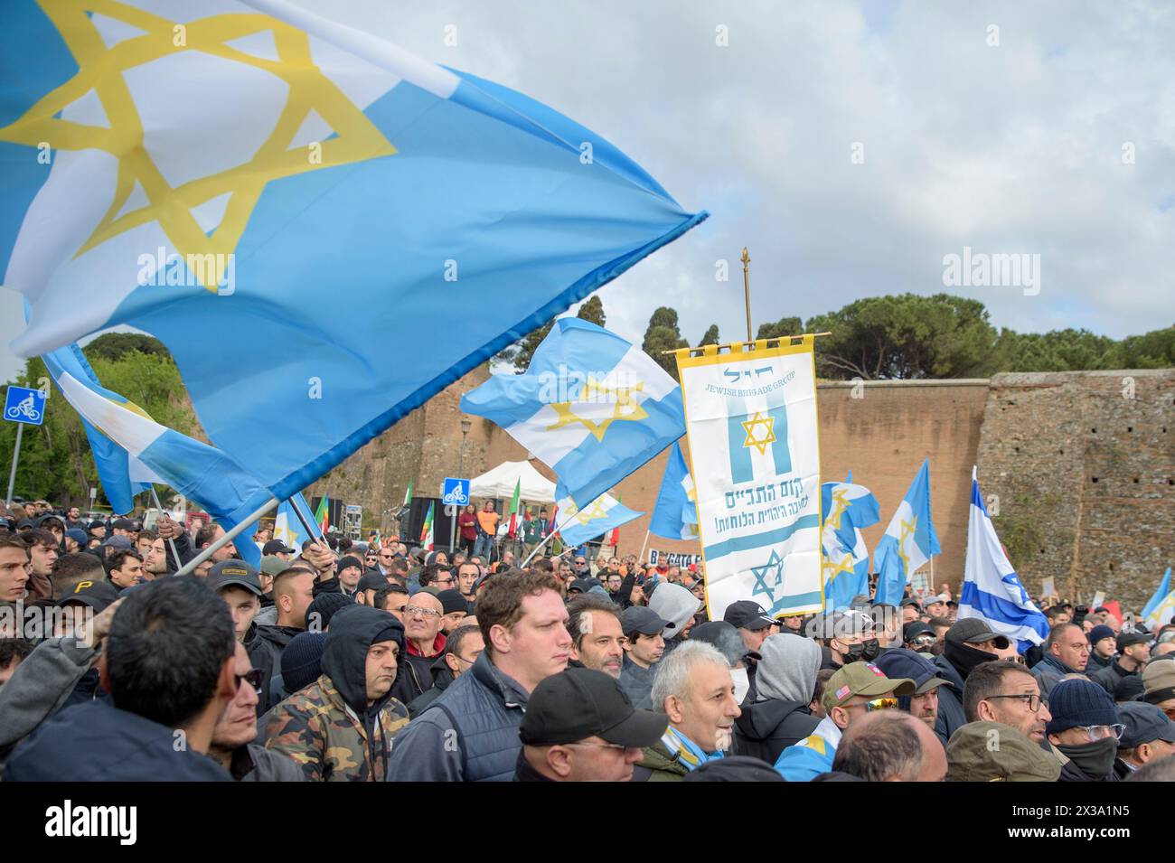 Rome, Italy. 25th Apr, 2024. Demonstrators from the Jewish Brigade display the symbol of the Jewish Brigade and wave flags with the Star of David during the April 25 celebrations look across the square where an 'anti-fascist and anti-Zionist' rally is taking place, organized by pro -Palestinian movements, to protest against the presence of 'Zionist symbols' during the demonstrations of April 25th (the day on which the liberation of Italy from Nazi occupation and fascism is commemorated) in Rome. (Credit Image: © Marcello Valeri/ZUMA Press Wire) EDITORIAL USAGE ONLY! Not for Commercial USAGE! Stock Photo