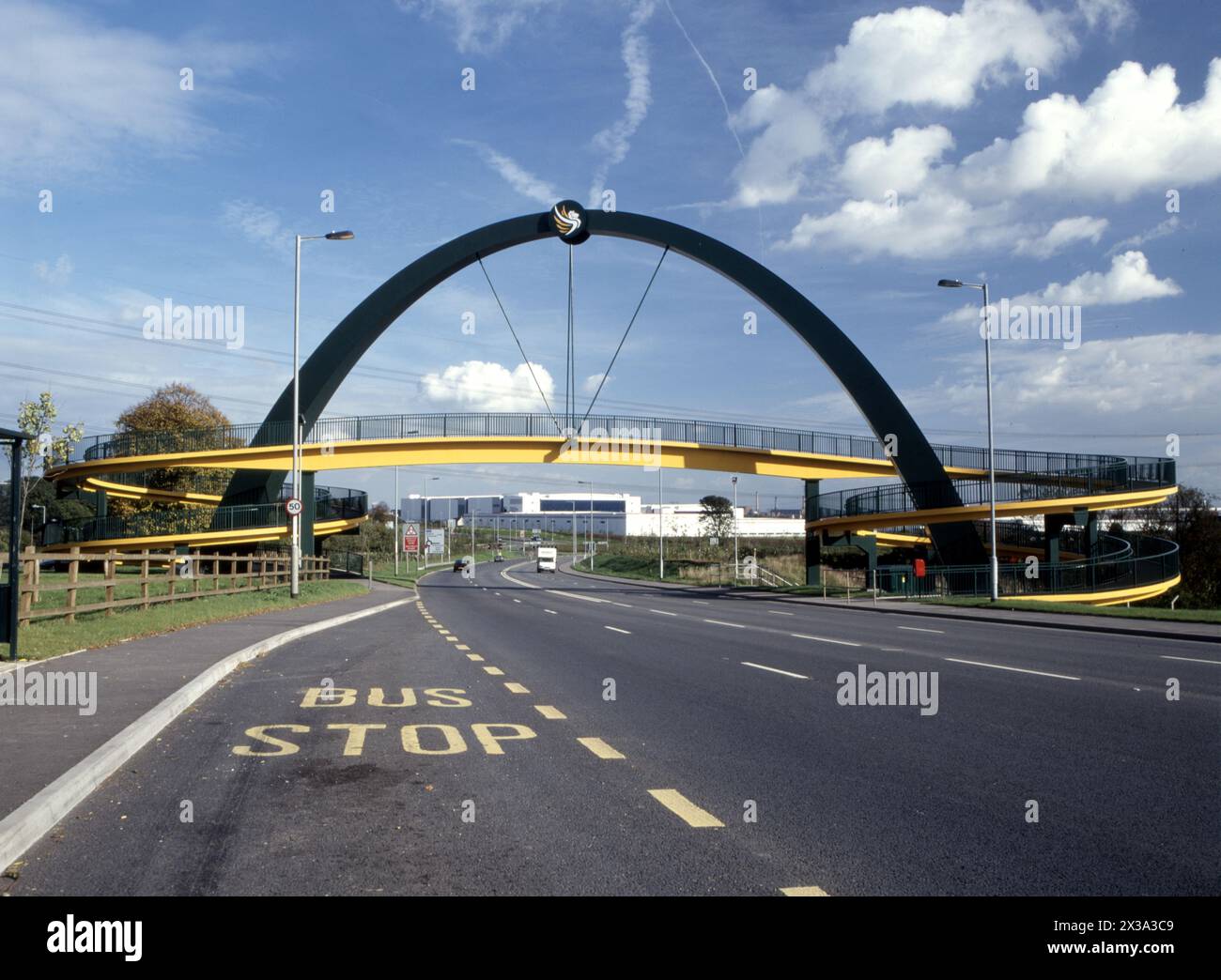 Pedestrian footbridge over A48 at Coedkernew, framing LG building nearby, acquired by Quinn Radiators and more recently sold to Microsoft. Stock Photo