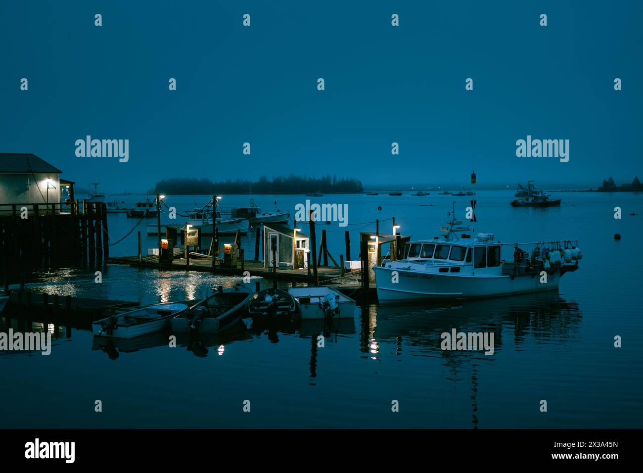 Boats in the harbor at night in Jonesport, Maine Stock Photo