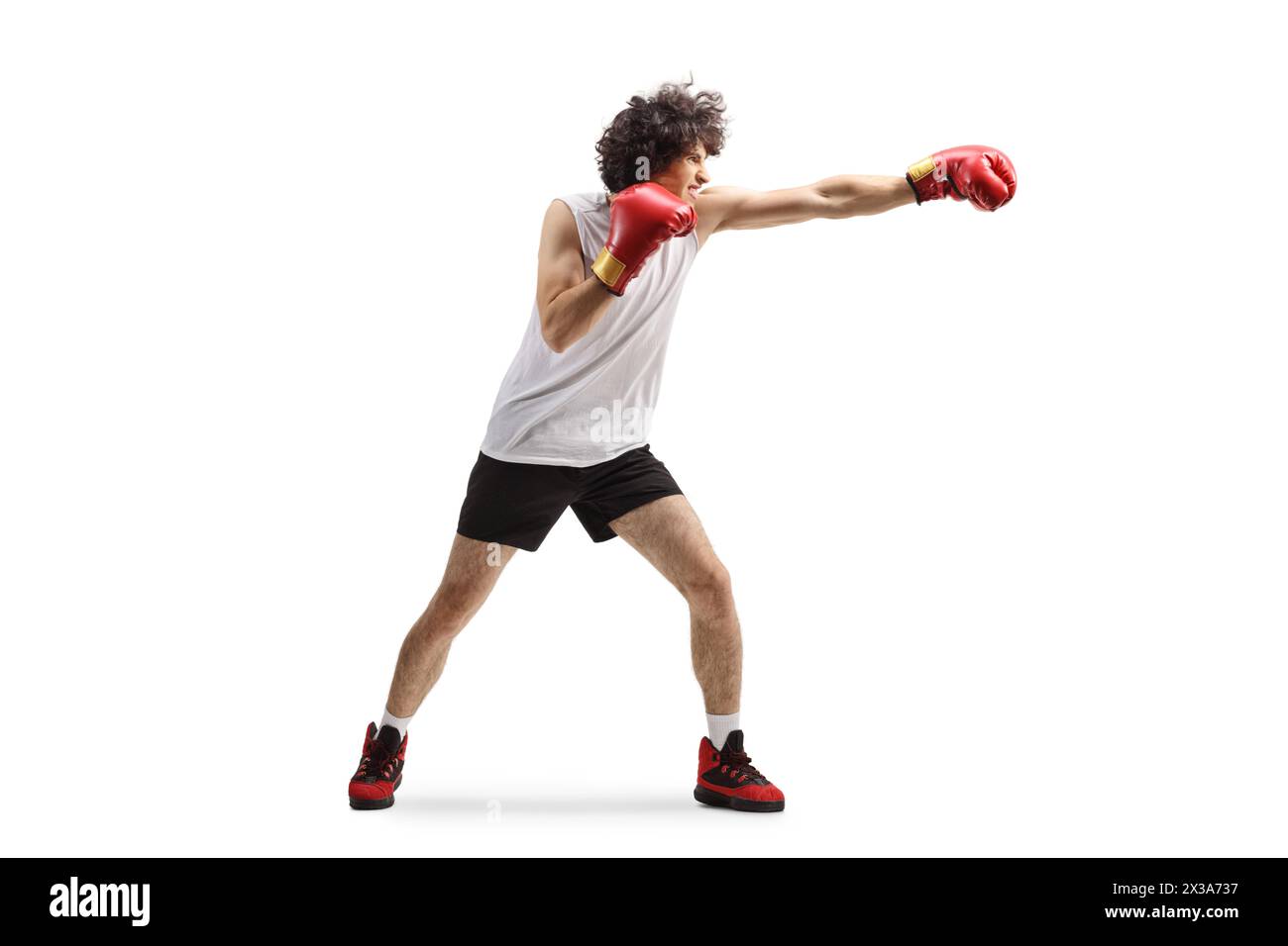 Young man punching with boxing gloves isolated on white background Stock Photo