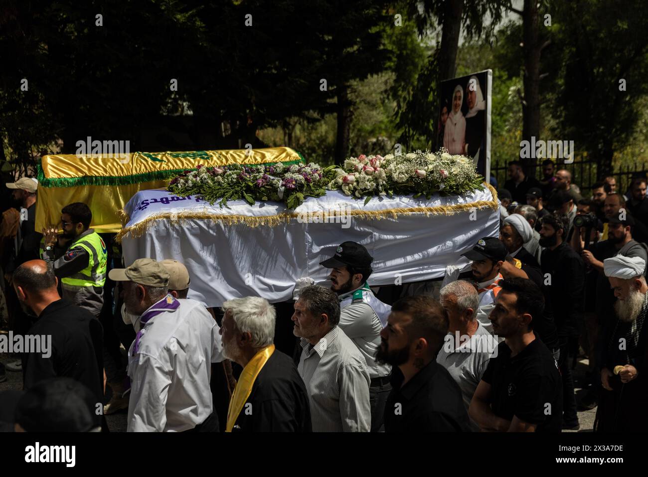 Hanin, Lebanon. 25th Apr, 2024. Men carry the caskets of Haj Maryam Qashqash, left, and Sarah Hussein Qashqash, 10, during their funeral procession at Hanin, Lebanon on April 25, 2024. They were killed April 23 by an Israeli airstrike that targeted their family home. (Credit Image: © Daniel Carde/ZUMA Press Wire) EDITORIAL USAGE ONLY! Not for Commercial USAGE! Stock Photo
