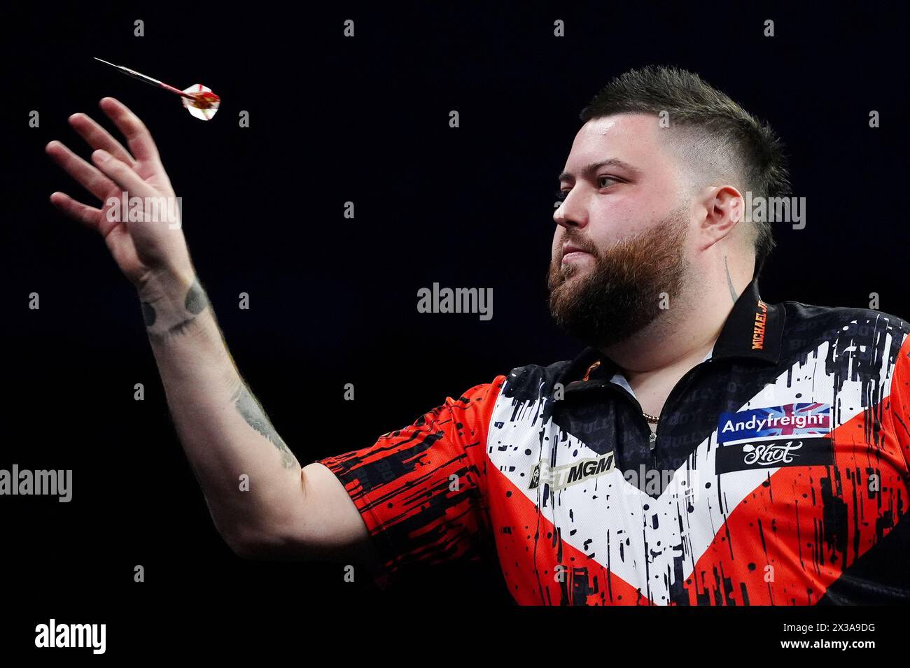 Michael Smith in action against Rob Cross (not pictured) on night thirteen of the 2024 BetMGM Premier League at the M&S Bank Arena, Liverpool. Picture date: Thursday April 25, 2024. Stock Photo