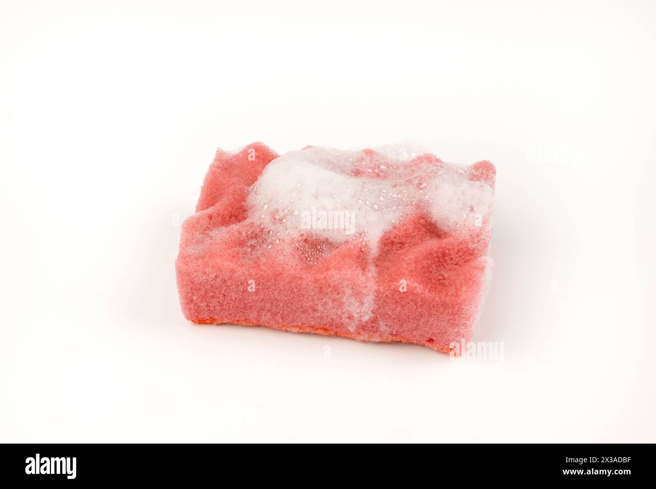 A sponge with soap suds isolated on a white background. Stock Photo