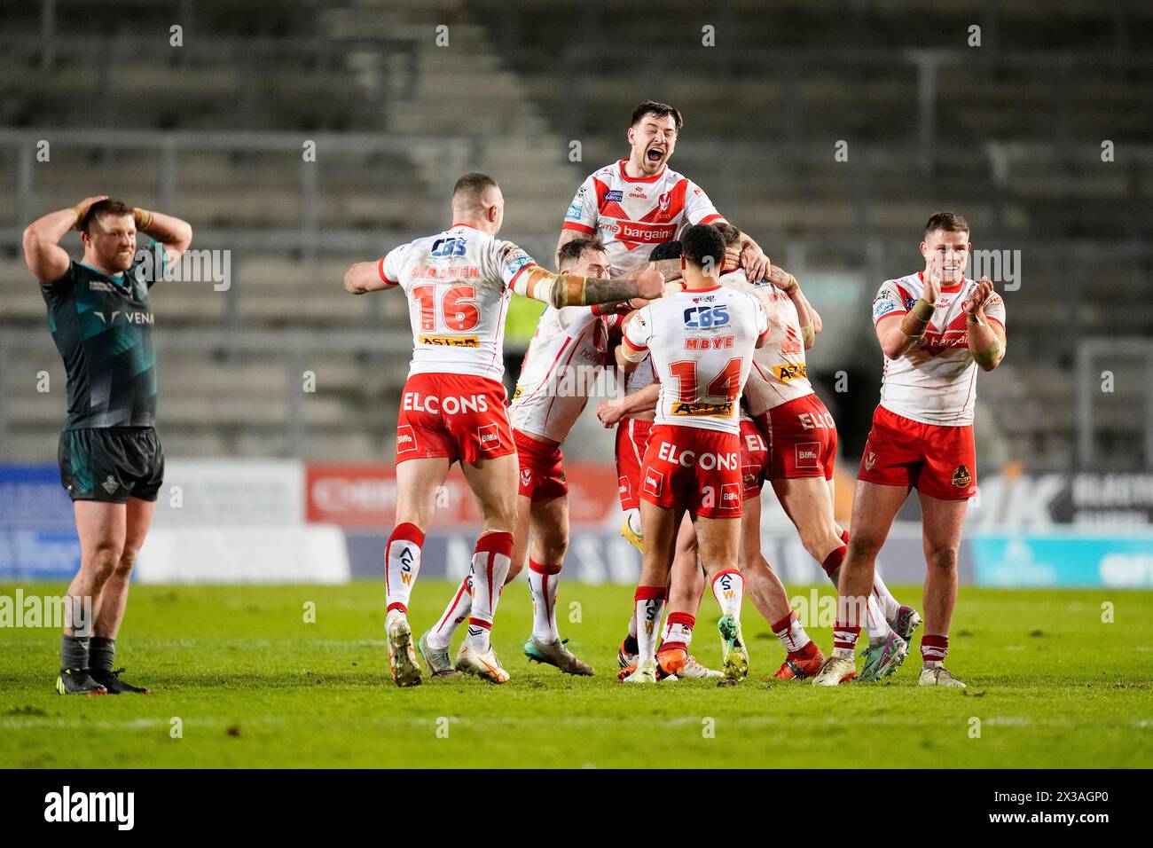 St Helens' Jonny Lomax (hidden) celebrates with team-mates after scoring their side's third conversion of the game during the Betfred Super League match at the Totally Wicked Stadium, St Helens. Picture date: Thursday April 25, 2024. Stock Photo