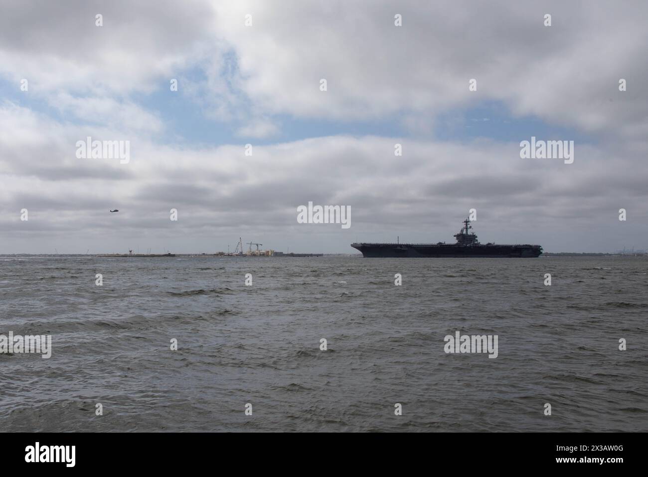 HAMPTON, Va. (April 25, 2024) The Nimitz-class aircraft carrier USS George Washington (CVN 73) crosses over the Hampton Roads Bridge Tunnel (HRBT), as it departs Naval Station Norfolk, April 25, 2024, for a deployment to the U.S. Southern Command area of operations as part of Southern Seas 2024. Following Southern Seas, George Washington is slated to relieve USS Ronald Reagan (CVN 76) as the forward-deployed naval forces (FDNF) aircraft carrier in Yokosuka, Japan. (U.S. Navy photo by Mass Communication Specialist 2nd Class Adonica Munoz) Stock Photo