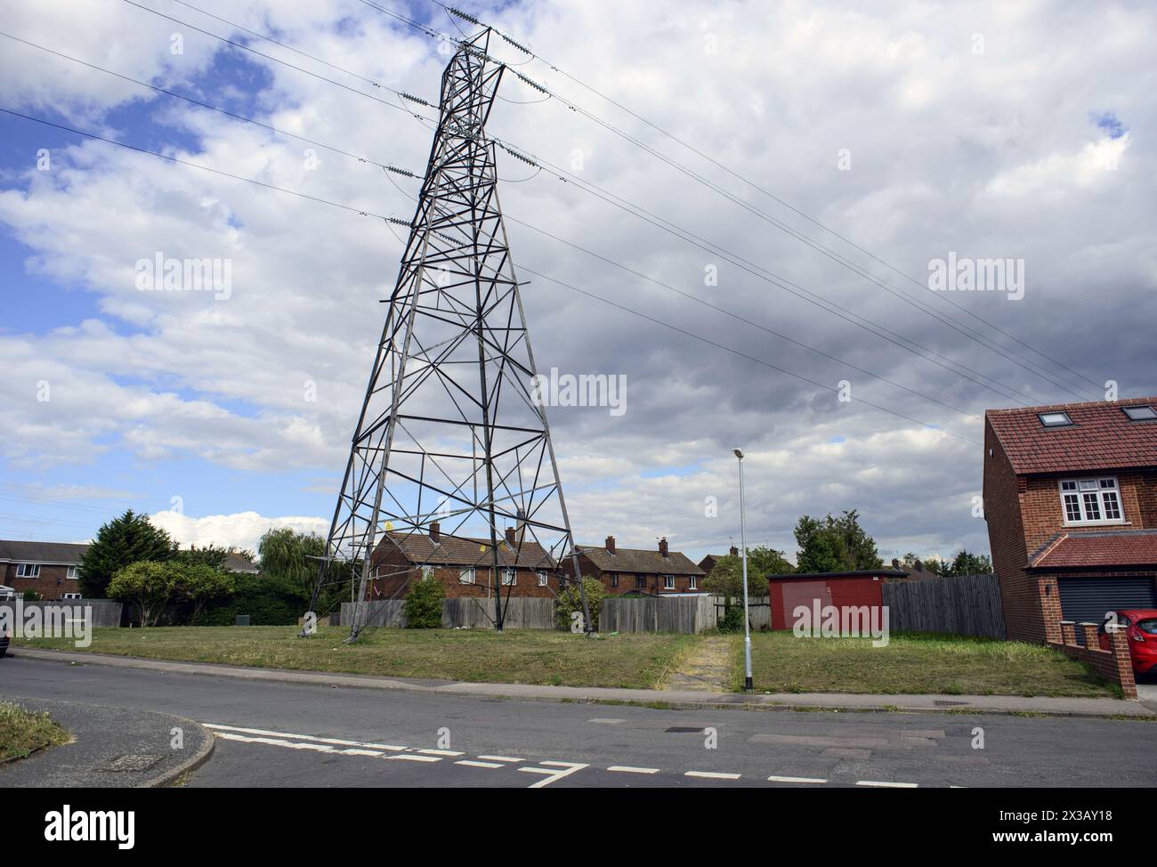 Electricity pylon and high voltage power lines in residential area ...