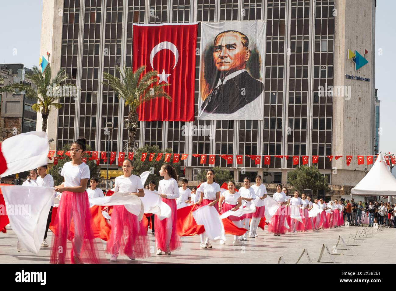 Izmir, Turkey - April 23, 2024: Joyful dance by children in red and
