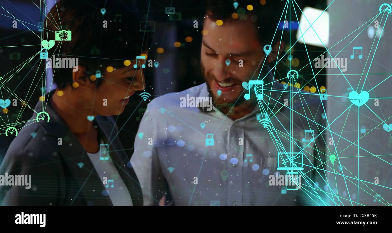 Image of network of connections with icons over people working together ...