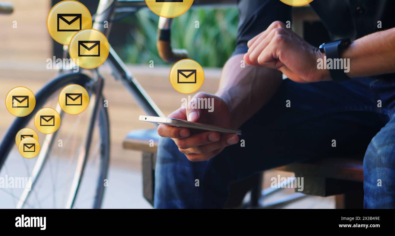 Image of envelope icons floating against mid section of man using smartphone in the background Stock Photo