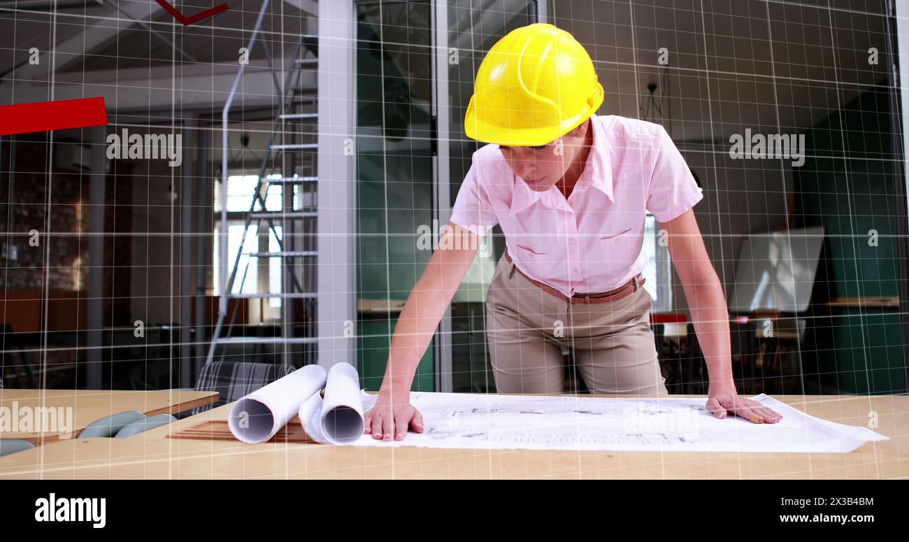 Image of red graph forming on a grid over Caucasian female worker looking at papers lying on a table Stock Photo
