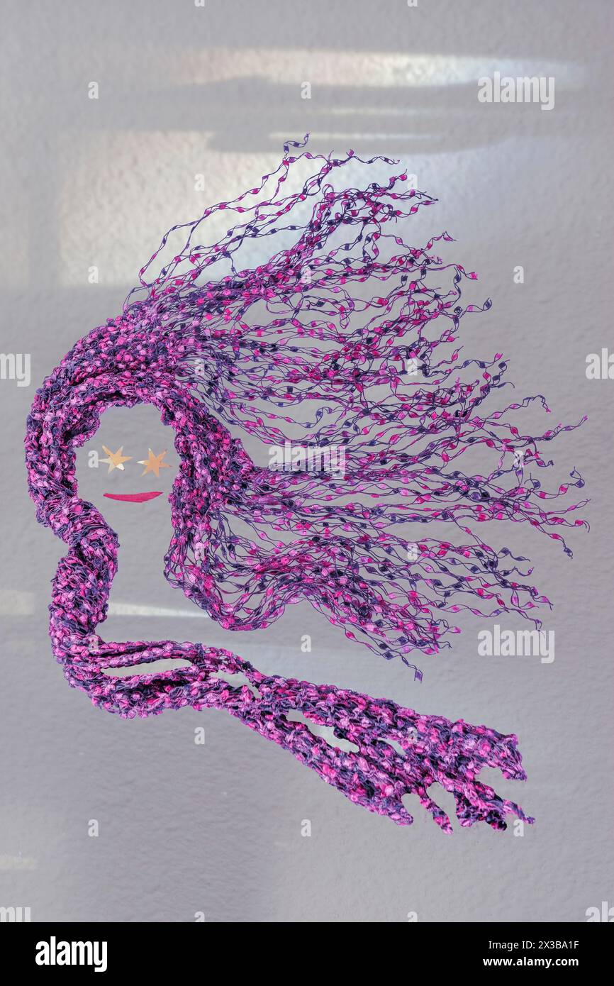 Abstra female composite displays pink hair in the desert wind. Cloth weaving shows tangled long strands of pink & purple.Starry eyes & mouth are added. Stock Photo