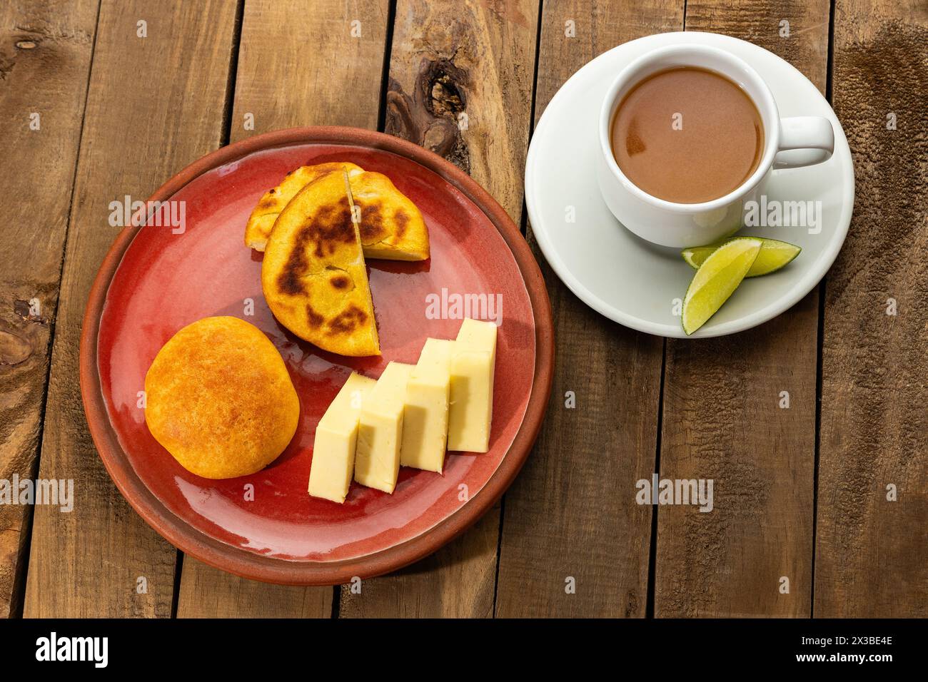 Boyacense breakfast with arepa, cheese, almojabana and aguapanela with lemon Stock Photo