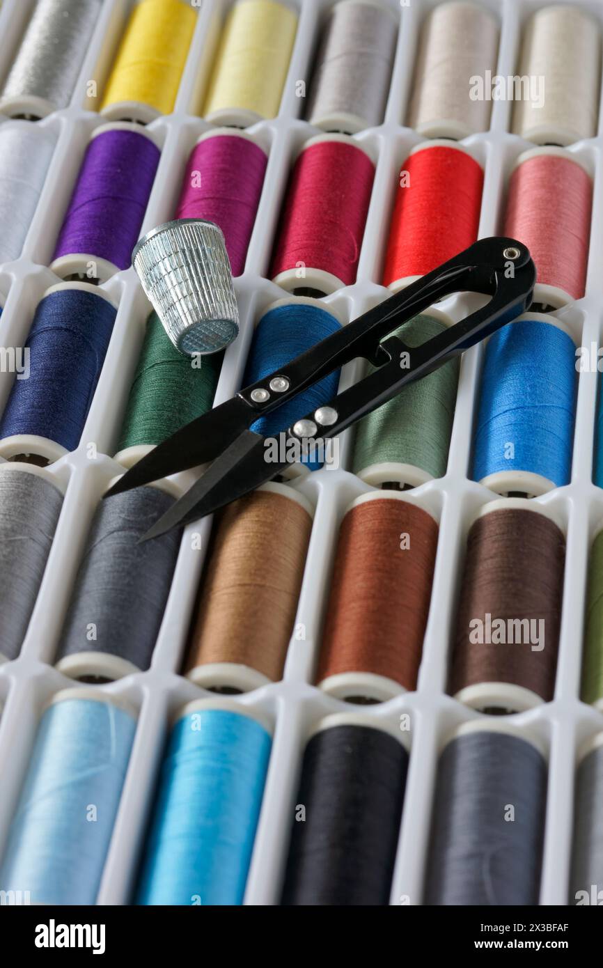 Sewing threads multicolored background closeup Stock Photo