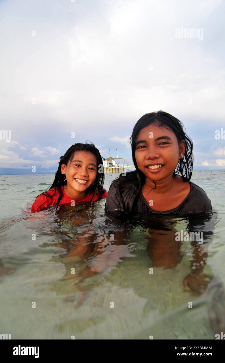 Filipina girls playing in  the water in Malapascua Island, Central Visayas, The Philippines. Stock Photo