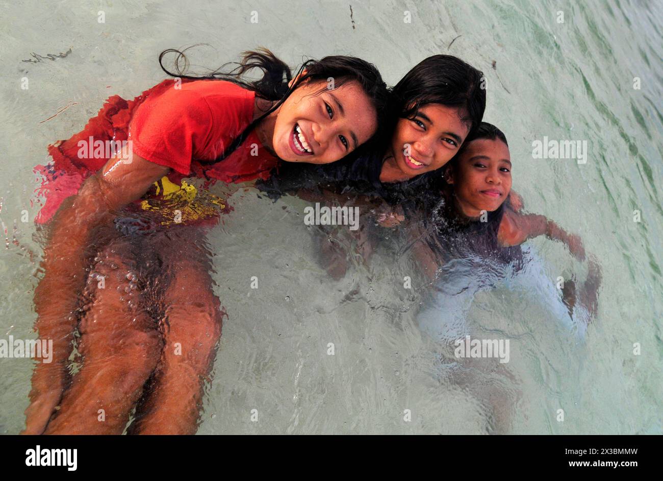 Filipina girls playing in  the water in Malapascua Island, Central Visayas, The Philippines. Stock Photo