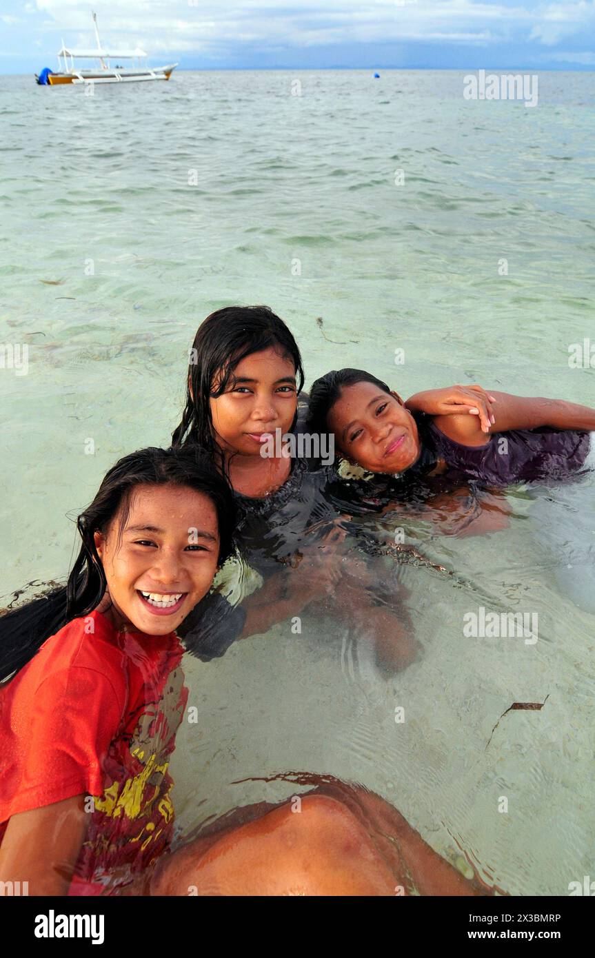 Filipina girls playing in  the water in Malapascua Island, Central Visayas, The Philippines. Stock Photo