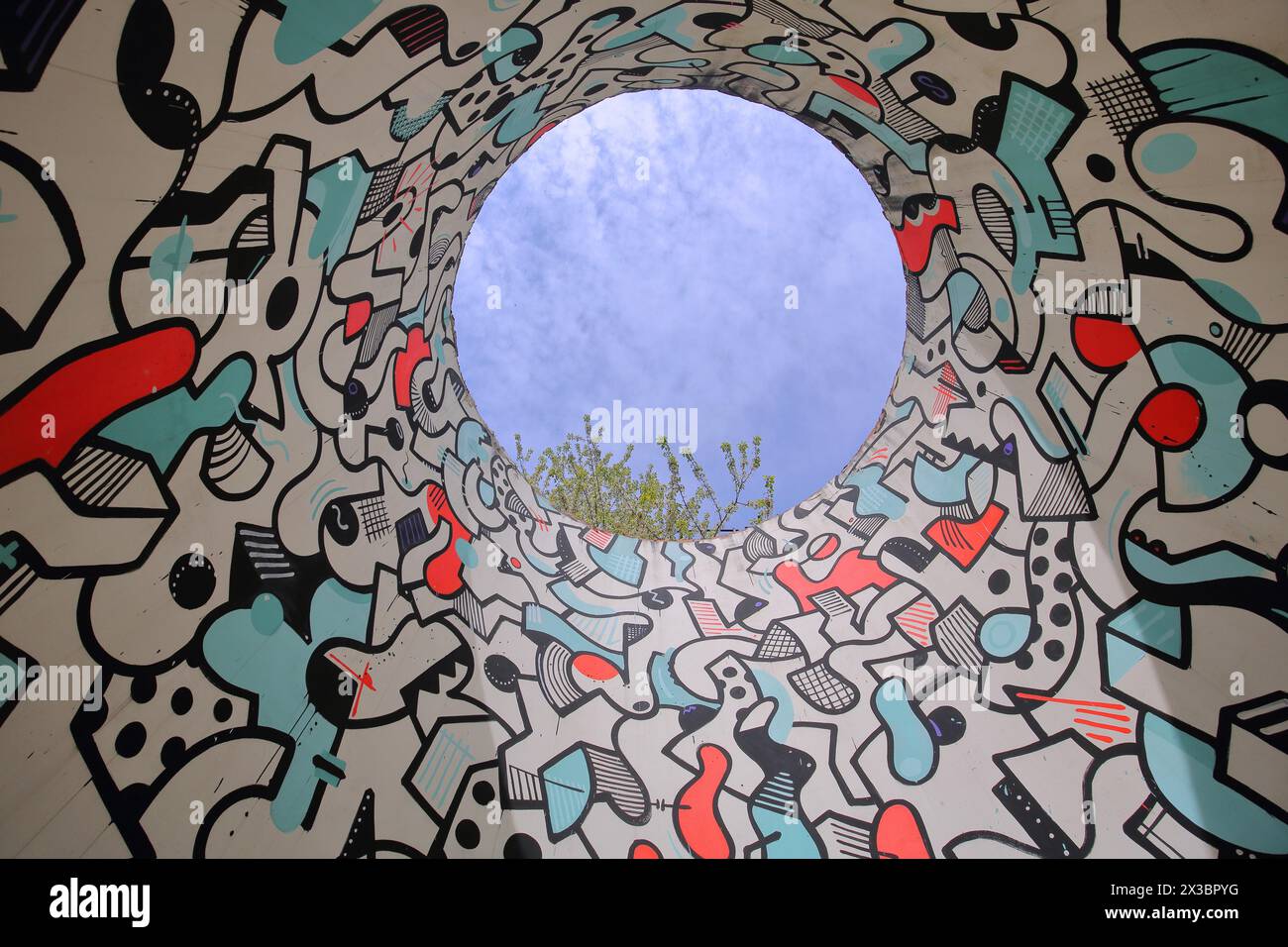 Sculpture Mambo by Bart Van Kersavond Biennale 2019, chimney, hole, pipe, round, circle, view upwards, pattern, white, red, black, blue, Voelklinger Stock Photo