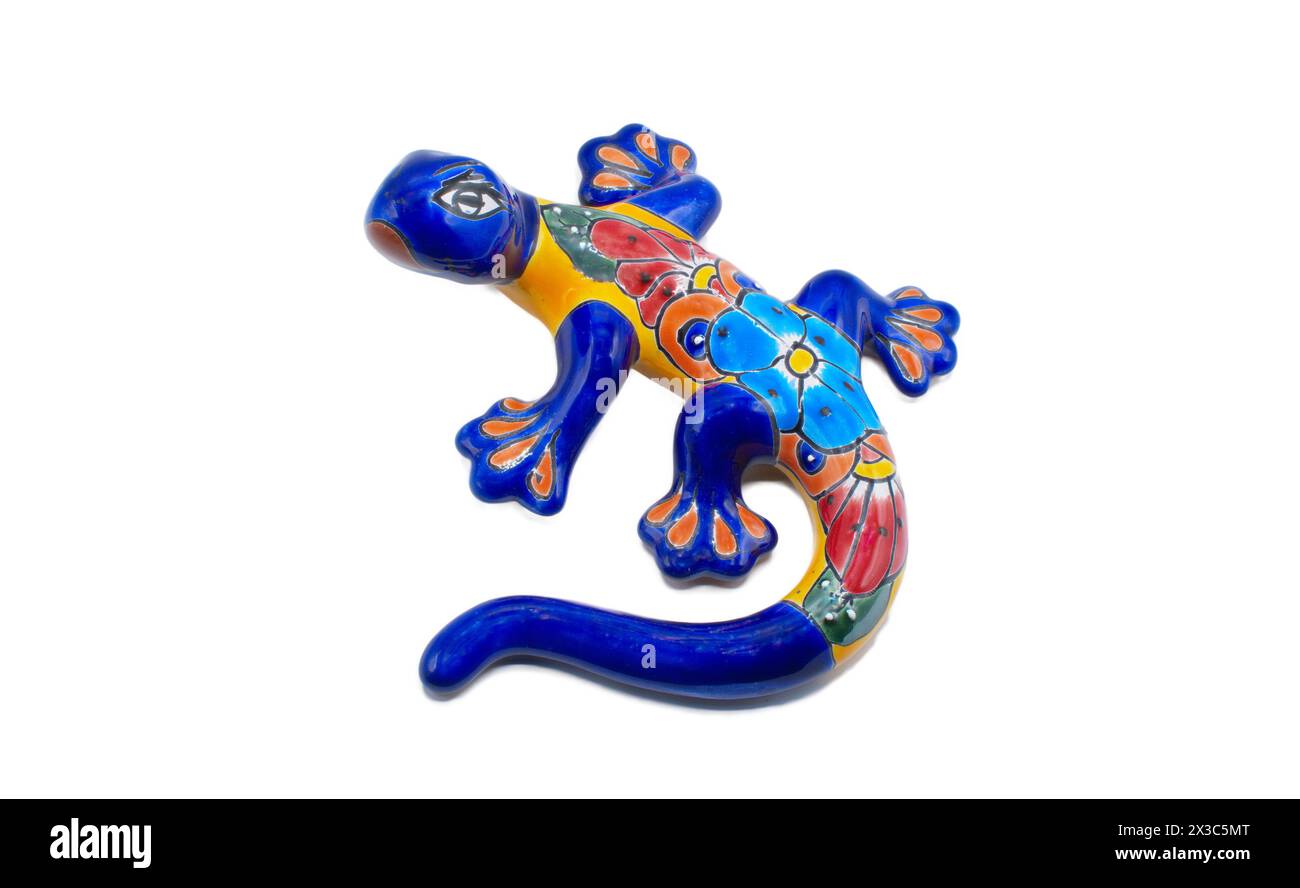 Mexican ceramic pottery of a salamander, gecko or lizard indoor outdoor wall art painted multi colored blue, red, yellow, orange with flower pattern d Stock Photo