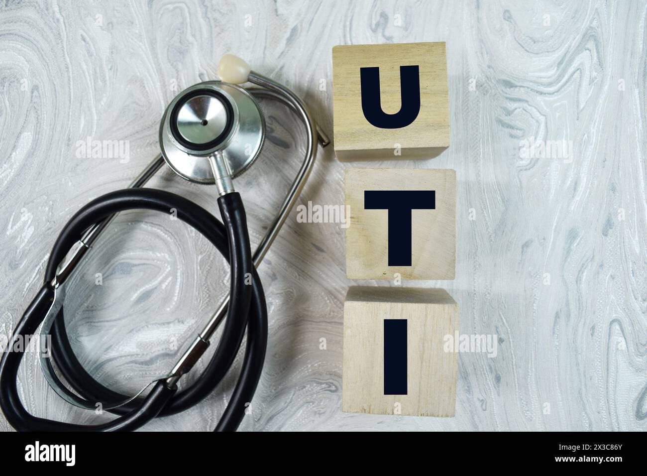 Concept of The wooden Cubes with the word UTI - Urinary Tract Infection on wooden background. Stock Photo