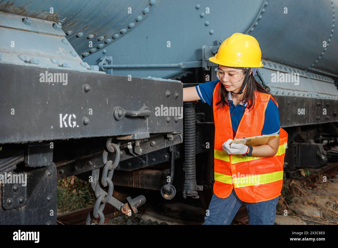 engineer women worker servicing check train. young teen maintenance locomotive rail transport vehicle. Stock Photo