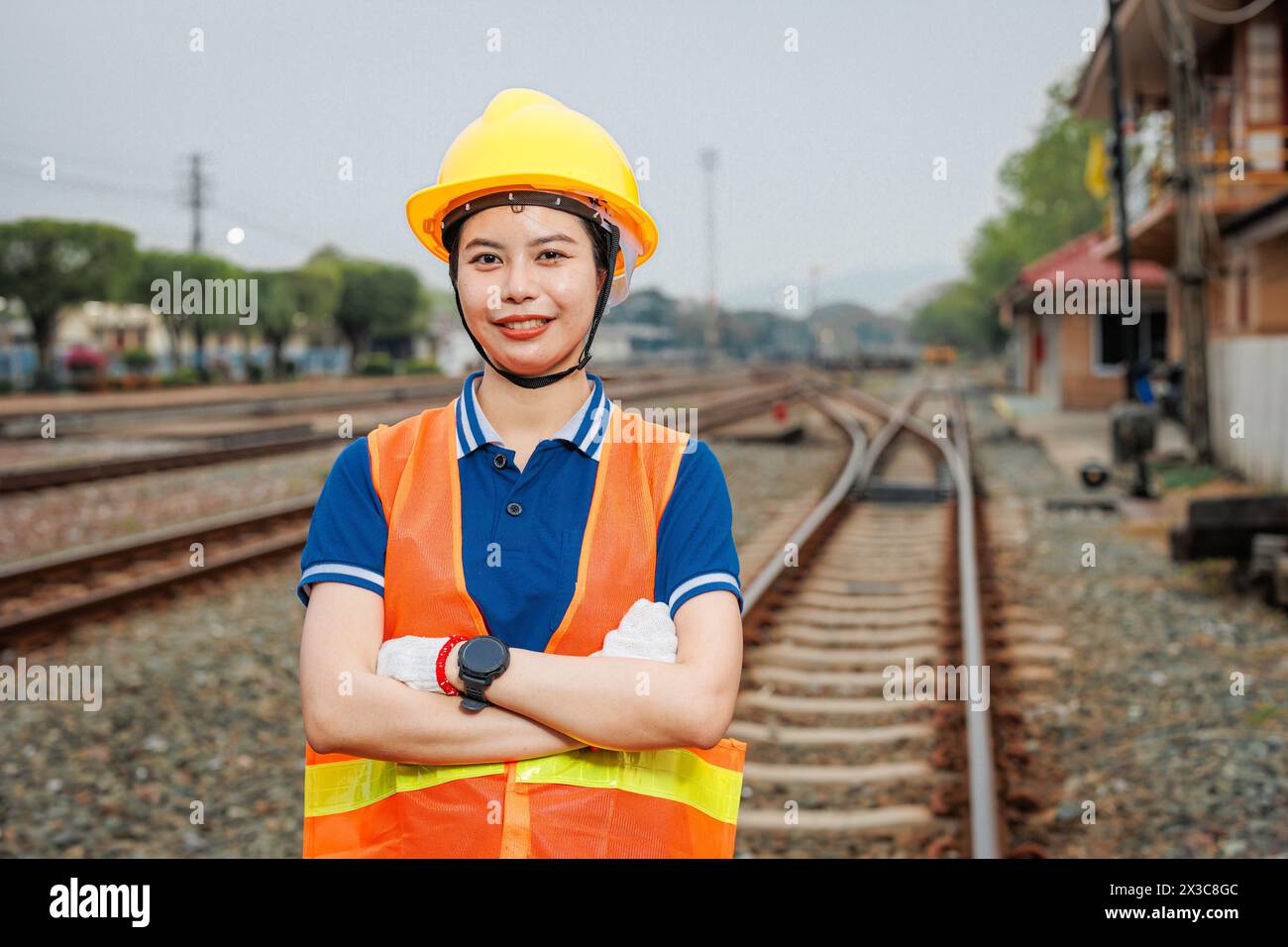 portrait train locomotive engineer women worker. Happy Asian young teen smiling work at train station train track locomotive service maintenance. Stock Photo