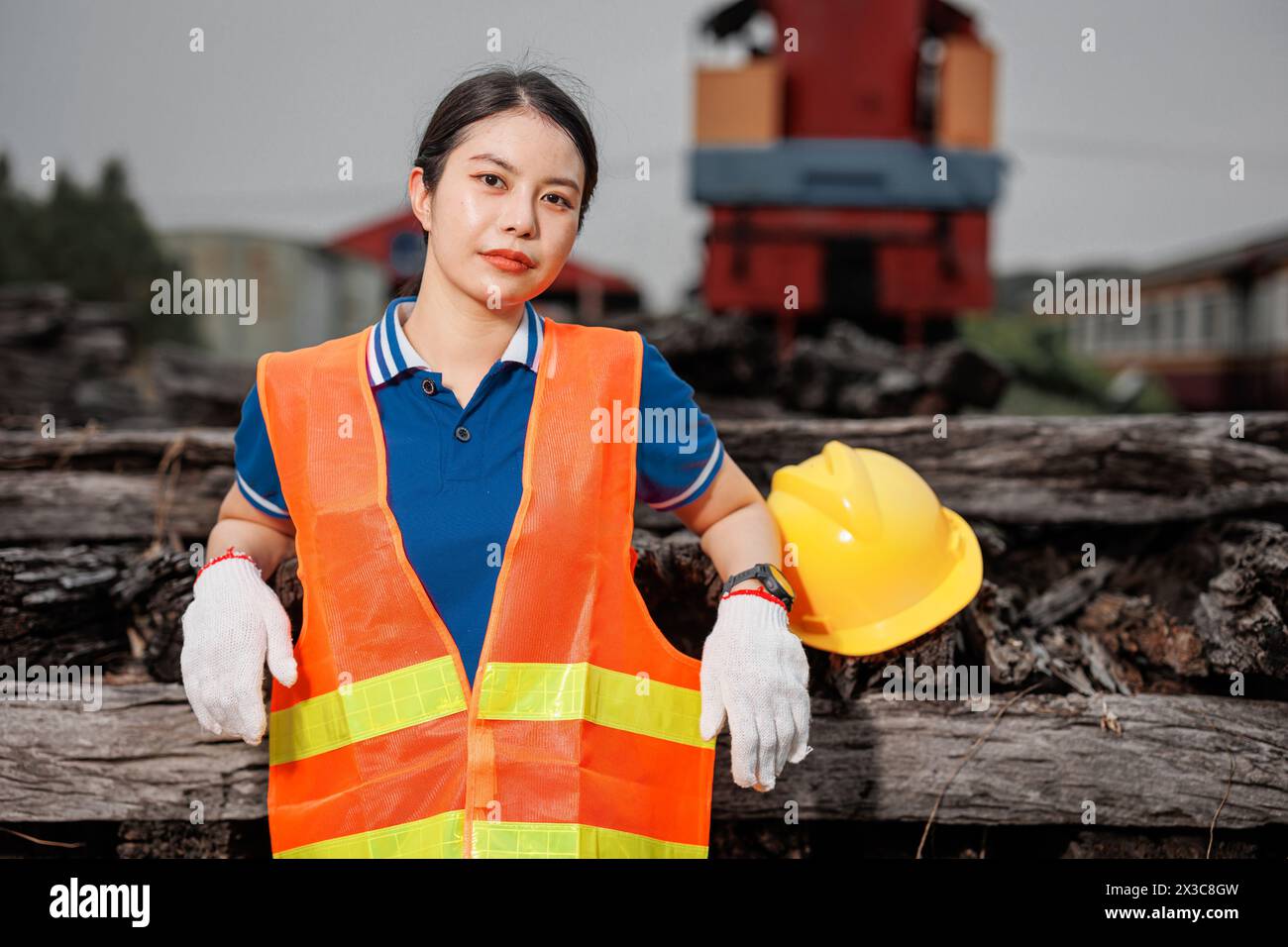 portrait Asian young teen engineer worker standing happy smile outdoor waring safety reflective with hardhat. Stock Photo