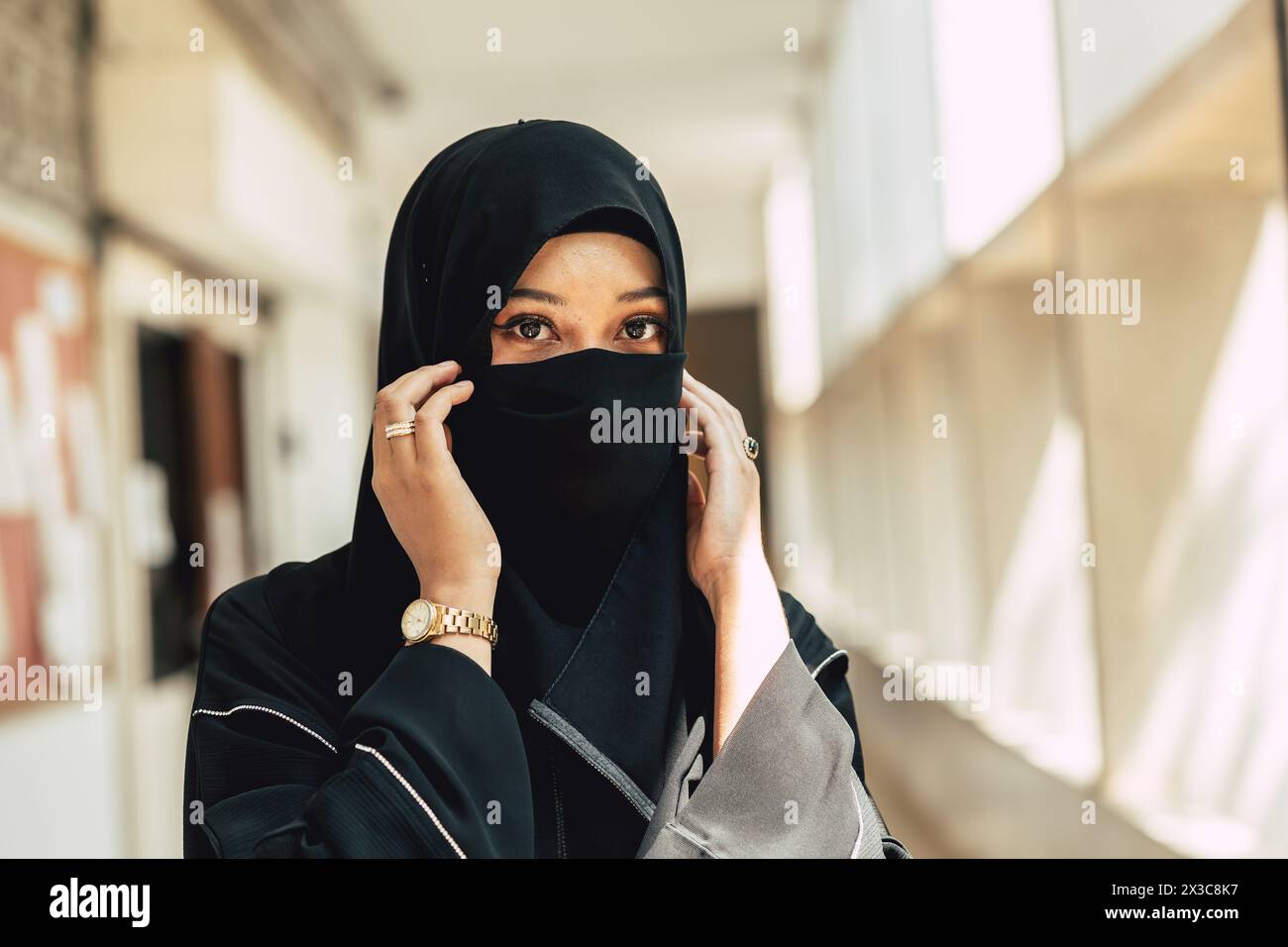 Muslim niqab woman close hide her face. Arab saudi girl closeup close face with black chador. Stock Photo
