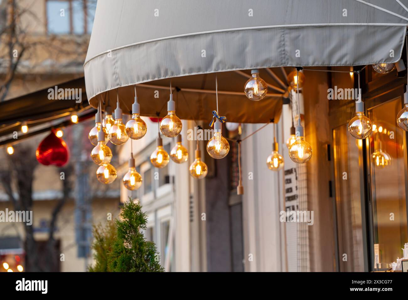 View of street beautiful modern coffee house interior with burning lights and ukrainian ribbon Stock Photo