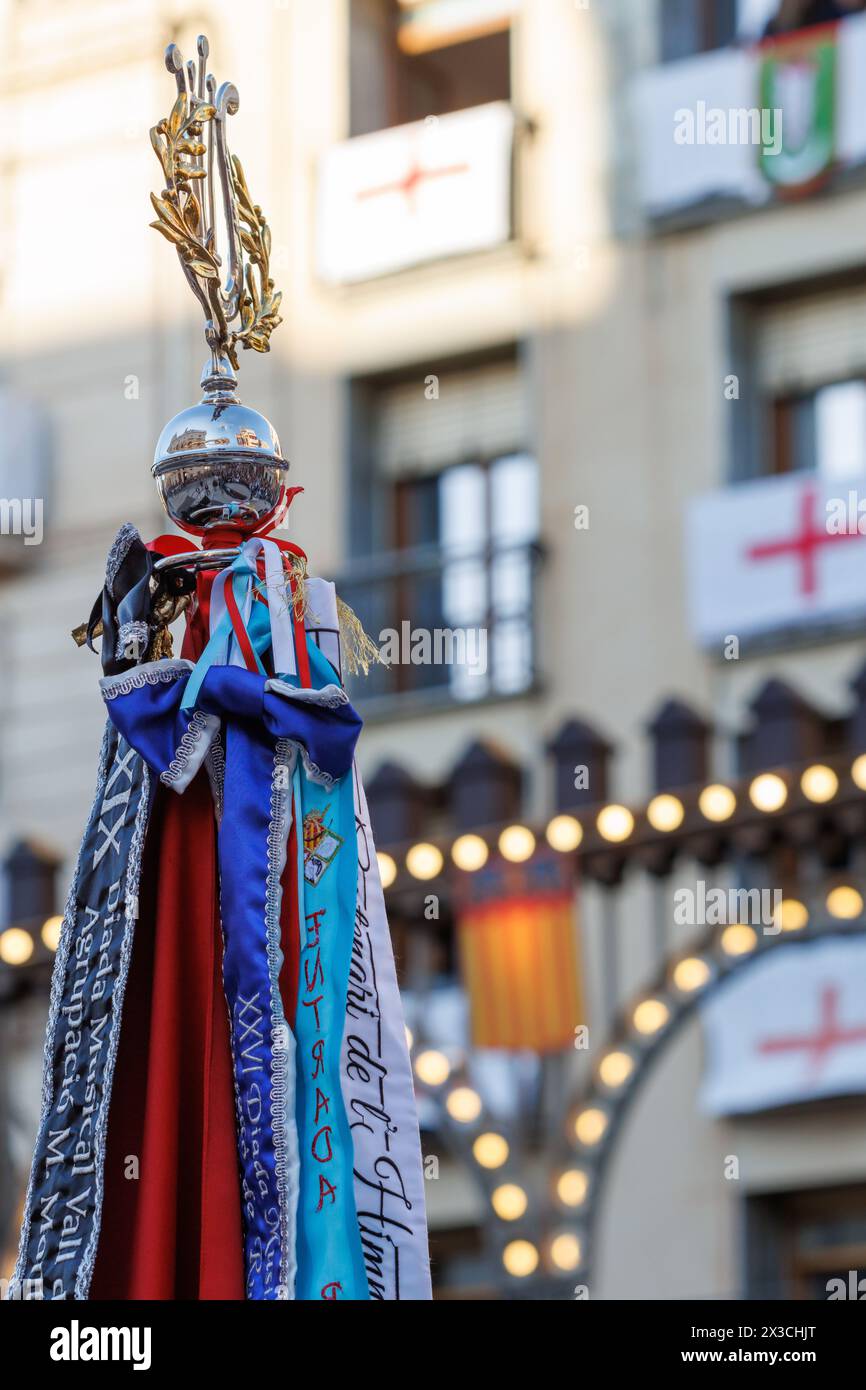 Flags of music bands with lighting background and balconies decorated with the flag of Saint George during the pasodoble festival in Alcoy Stock Photo
