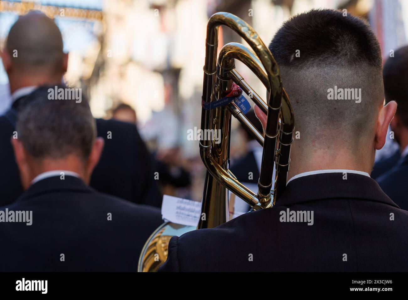 04-19-2024: Close-up of a music band from behind parading at the pasodoble festival prior to singing the festival anthem of Alcoy, Spain Stock Photo