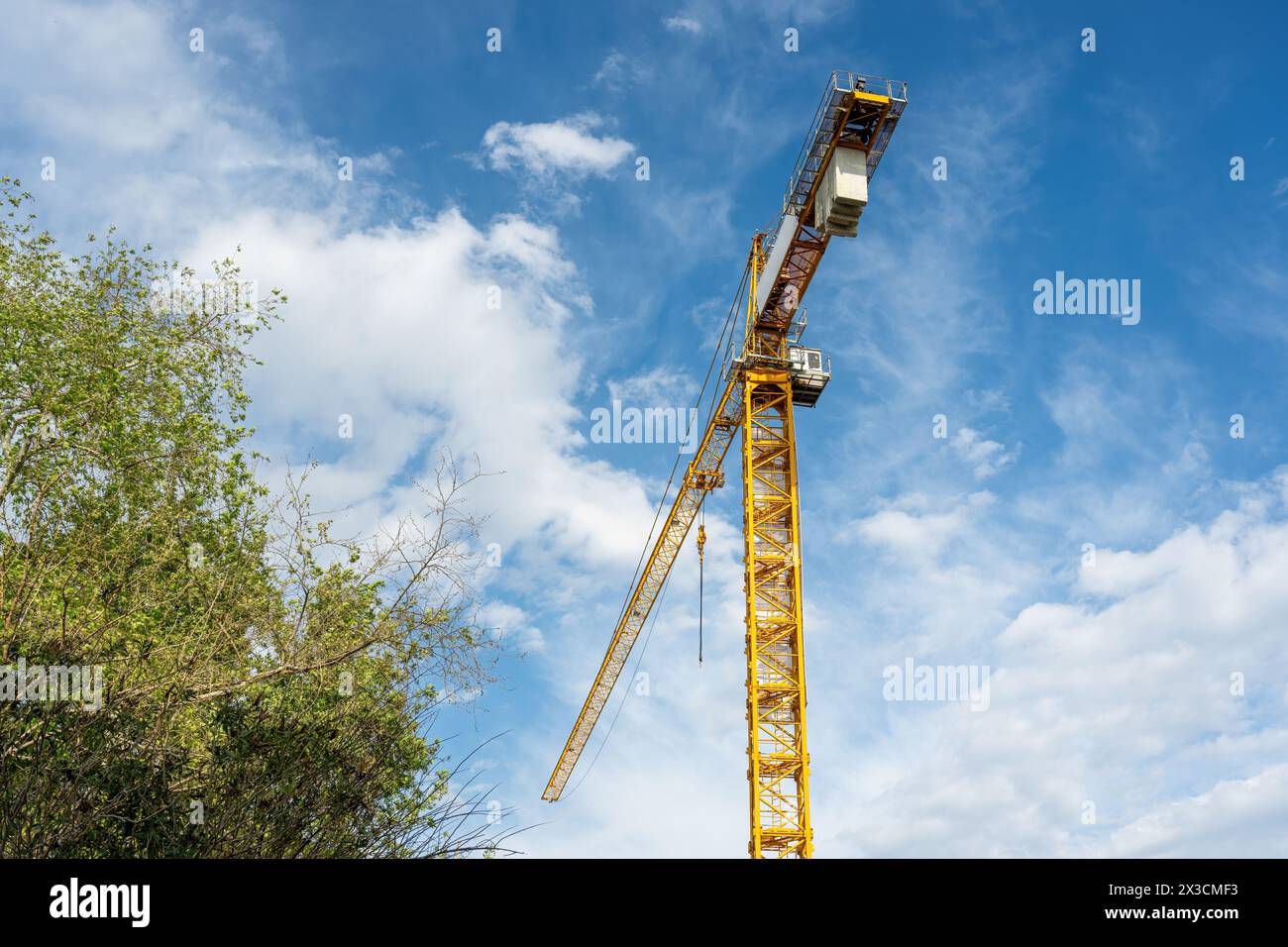 Construction crane working on large construction site Stock Photo