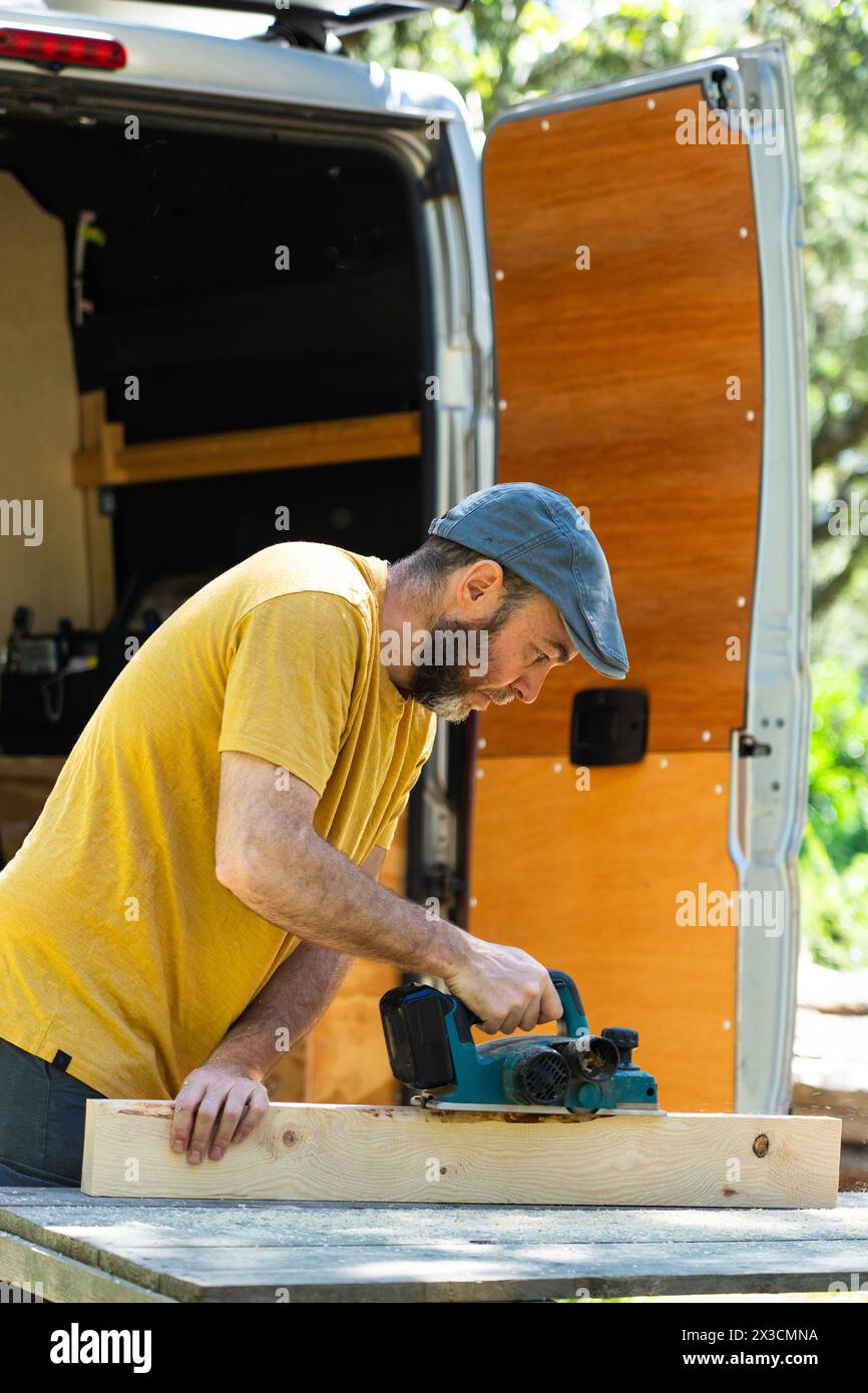 Man working to camperize his camper van Stock Photo